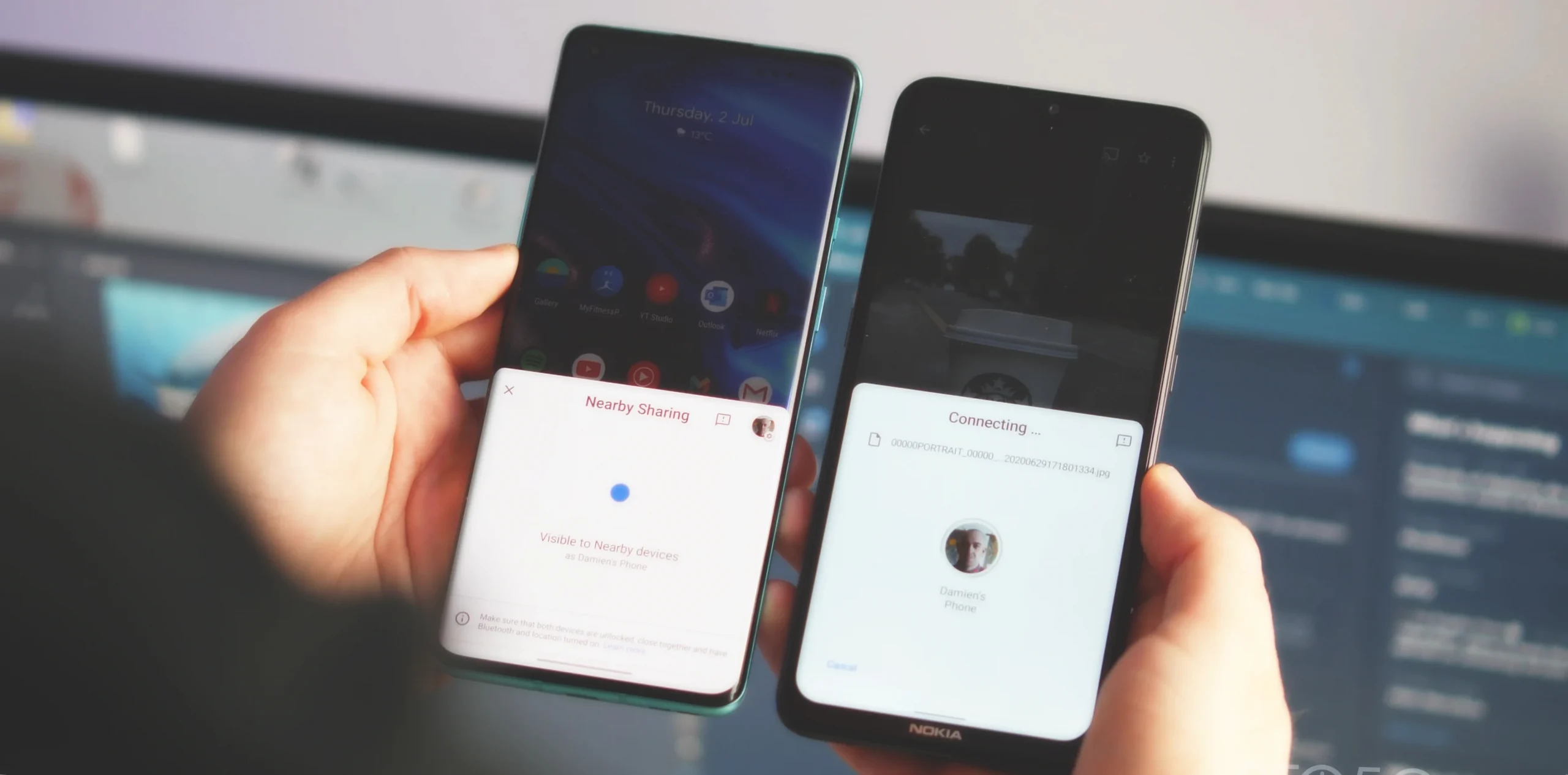 Two smartphones in two hands connecting